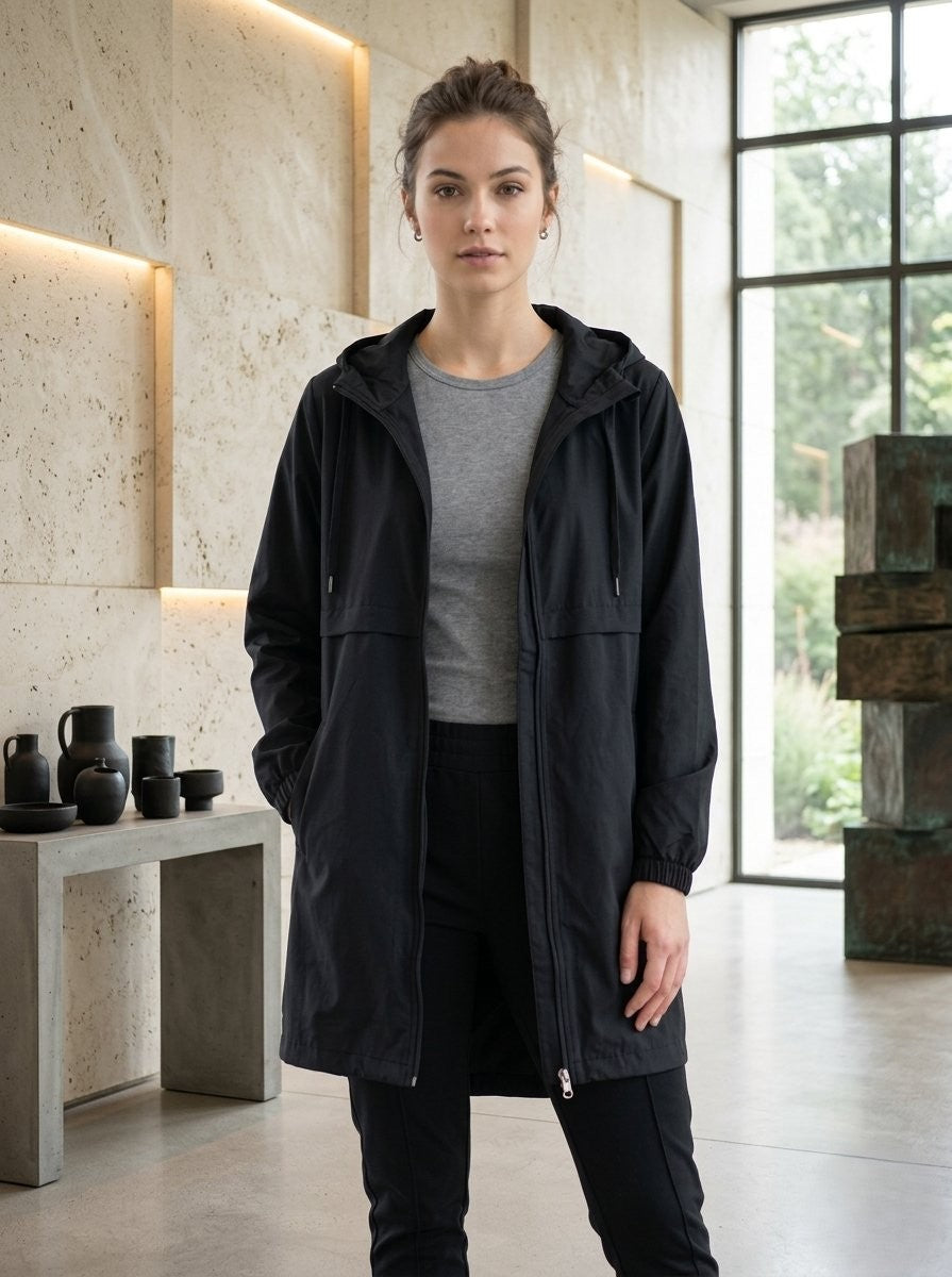 Minimalist black mid-length windbreaker jacket