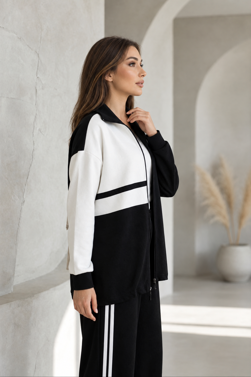 Black-and-white tracksuit on a model with uncovered hair